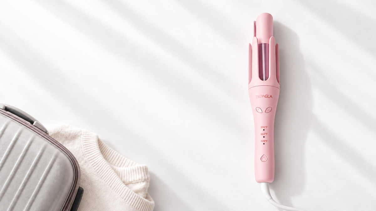 Upright pink T309 with connected cord beside travel luggage and an ivory knit